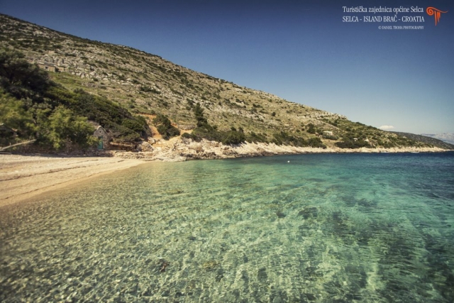 Crystal clear sea water in front of pebble beach on the island of Brac