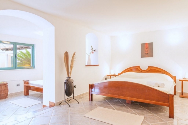 Double bedded room with single bed in minimalist bedroom in the Villa Rasotica